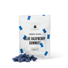 A close-up image of BuudaBomb Blue Raspberry Gummies, with the white packaging featuring small blue gummy bears and a pile of blue raspberry-flavored gummies in front