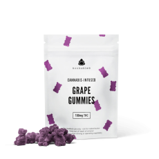 A close-up image of BuudaBomb Grape Gummies, with the white packaging featuring small purple gummy bears and a pile of purple grape-flavored gummies in front