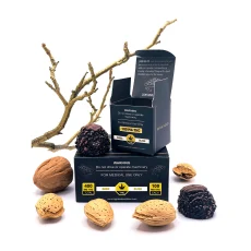 High Heals Dark Bliss THC truffles box open with dark chocolate truffles and assorted walnuts and almonds scattered around. The box displays '100mg THC per truffle' and '400mg THC total' with medical warnings visible