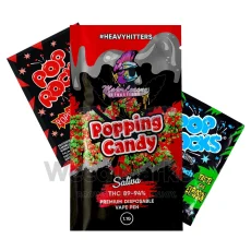 Major League Extractions Popping Candy-flavored Sativa disposable vape pen packaging, featuring vibrant popping candy graphics. The vape pen contains 89-94% THC and is labeled as a 1.1g premium disposable vape pen under the #HeavyHitters label.
