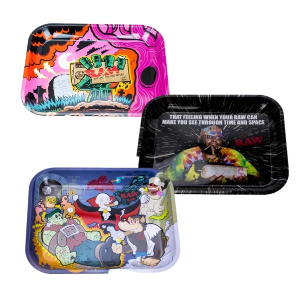 : A collection of three colorful RAW Rolling Trays. The top left tray features vibrant pink and orange artwork with rolling paper and flame motifs. The top right tray has a cosmic theme with a man in a tie-dye shirt and the text: "That feeling when your RAW can make you see through time and space." The bottom tray has cartoon-style artwork with monsters, including a vampire, Frankenstein, and a werewolf smoking in a lively scene. Each tray has rounded edges and deep walls for easy rolling.