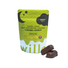 A bag of Willo cannabis-infused milk chocolate-covered caramel crunch labeled for nighttime (indica), with two chocolate pieces displayed beside it. The packaging features a dark green theme with a crescent moon and stars design.