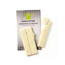 Kush Kitchen Cookies and Cream chocolate bar broken into white chocolate pieces with cookie bits showing 200mg THC on grey packaging.
