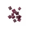 Grape hard candy pieces in deep purple arranged on a white background.