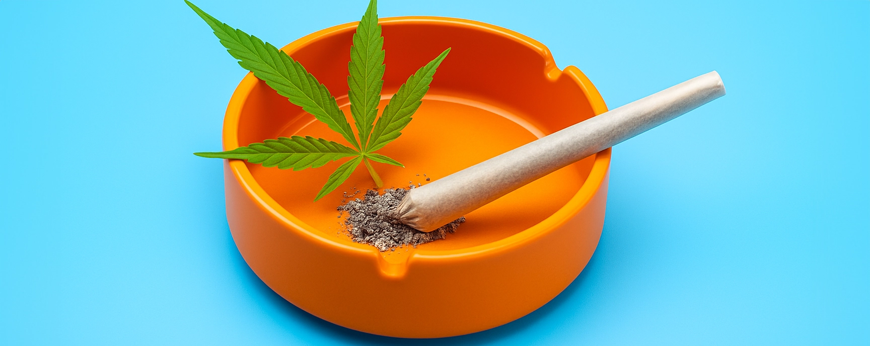 Bright orange weed ashtray with a cannabis leaf and joint on a vivid blue background.