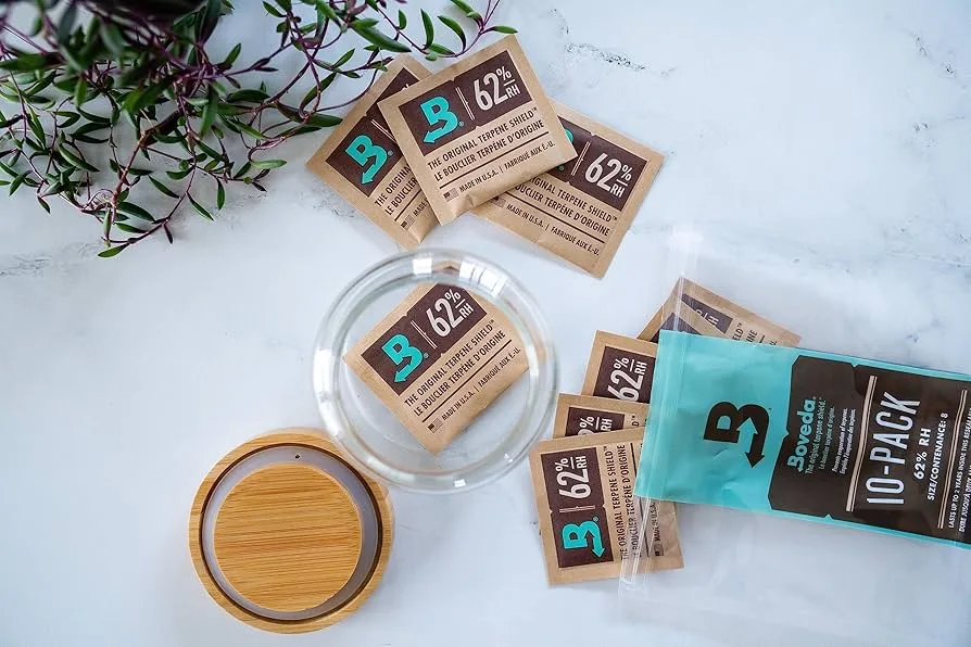 Boveda packs scattered on the table used to preserve terpenes in cannabis
